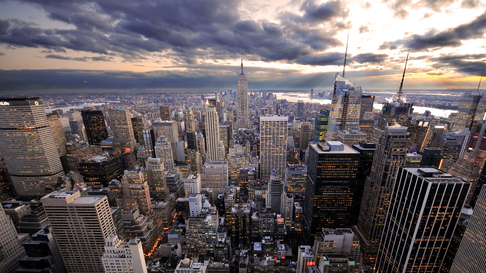 Aerial view of New York City skyline under dramatic dusk clouds.