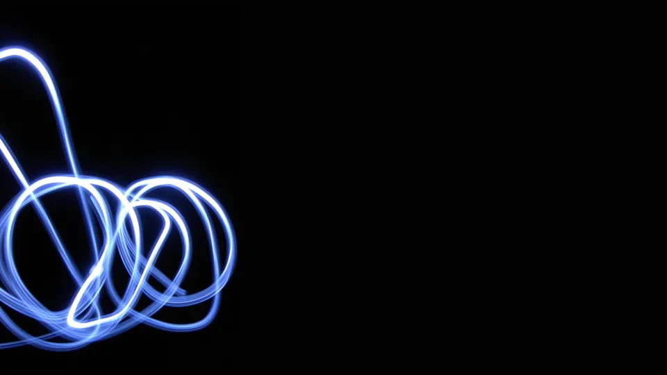 Abstract blue light trails swirl and loop against a solid black background.