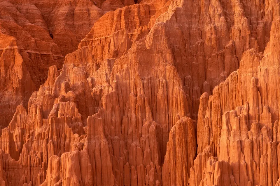 Close-up view of tall, eroded sandstone formations in shades of orange and red.