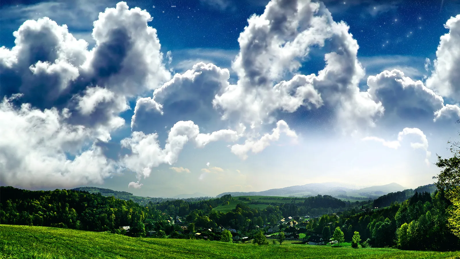 A panoramic view of large, fluffy cumulus clouds against a blue sky with visible stars, above a lush green landscape with rolling hills and a small village.