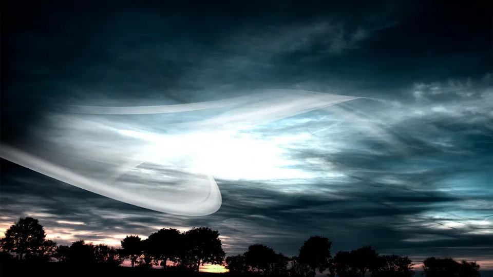 A dramatic sky with swirling white and blue clouds, silhouetted trees at the bottom.