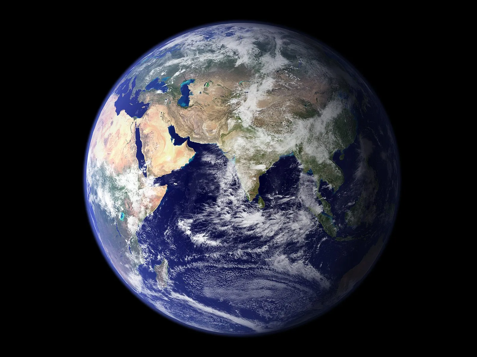 A view of planet Earth from space, showing continents and clouds against a black background.