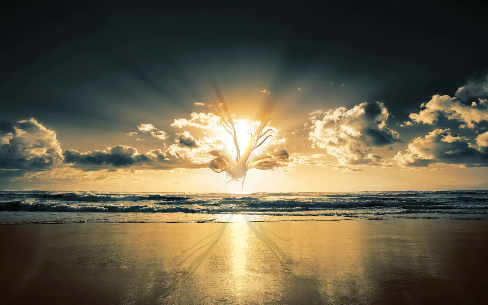 A dramatic sunset over the ocean with sun rays breaking through dark clouds and reflecting on the wet sand.