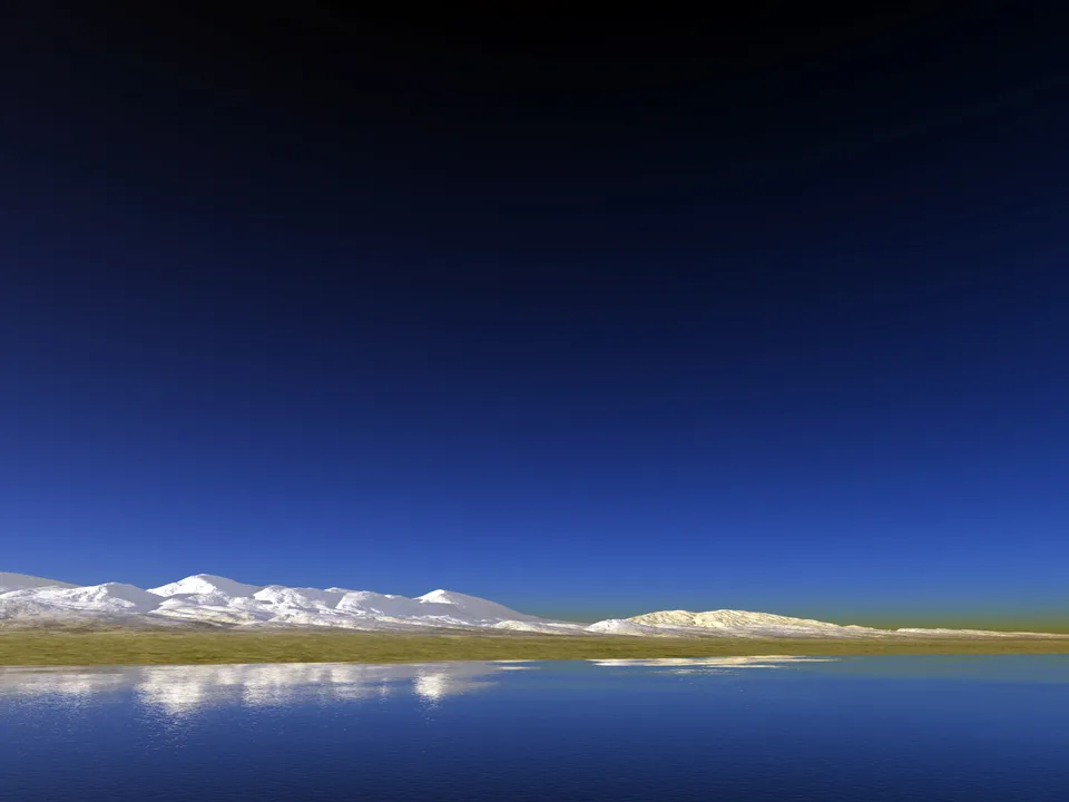 Snowy mountains are reflected in a deep blue lake under a clear sky.