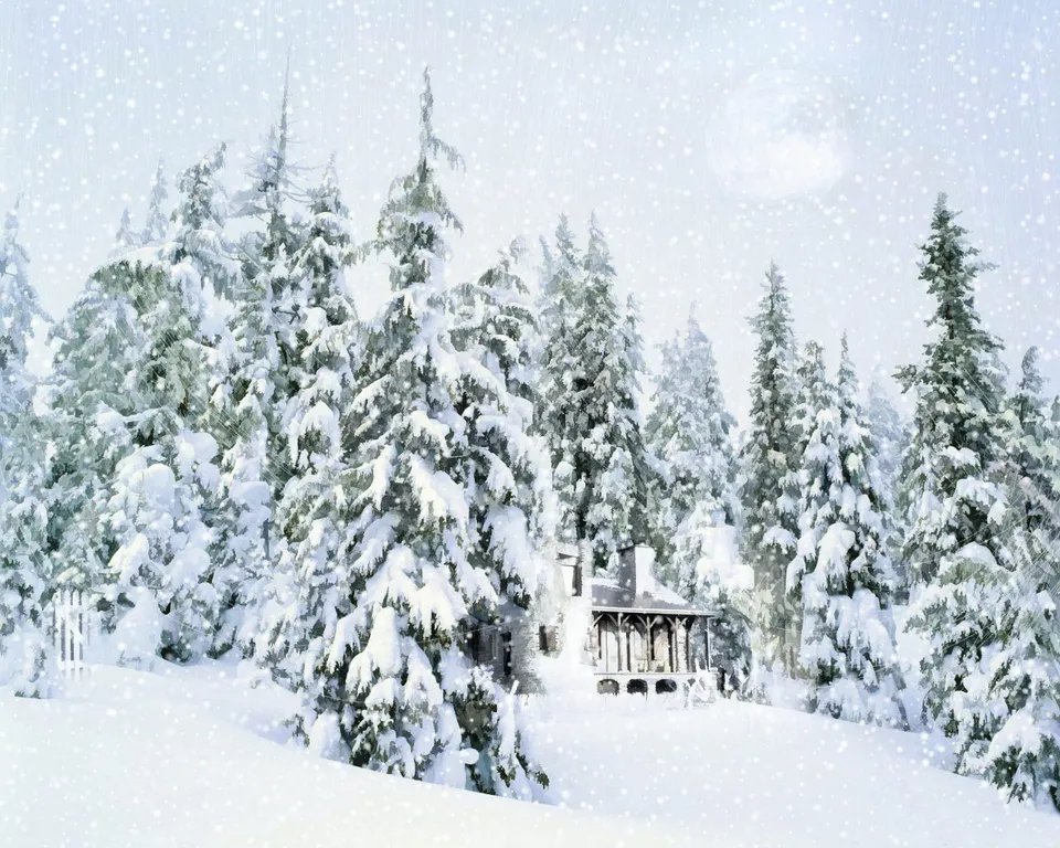 A quaint cabin with a porch is surrounded by snow-covered evergreen trees during a snowfall.