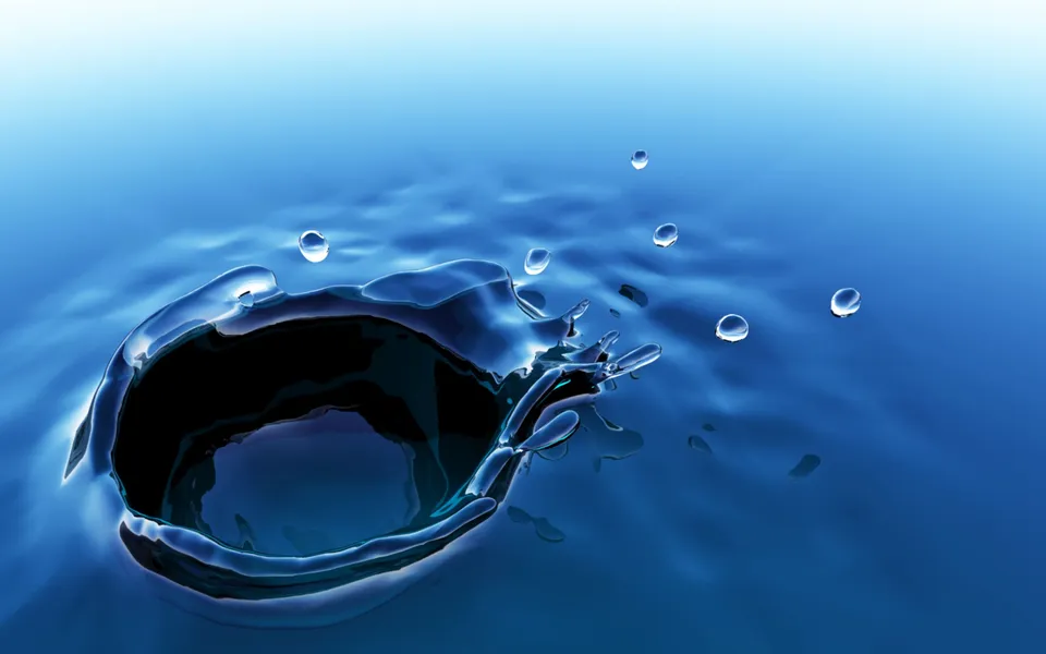 A close-up of a water splash with several droplets suspended in the air.